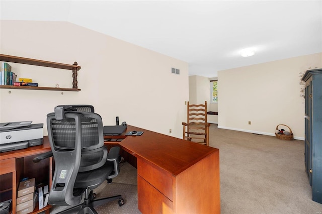 home office featuring lofted ceiling and light colored carpet