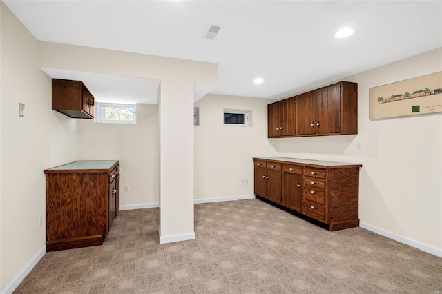 bar with dark brown cabinetry and light colored carpet