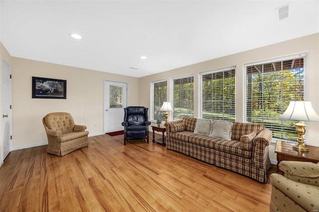 living room with plenty of natural light and light hardwood / wood-style flooring