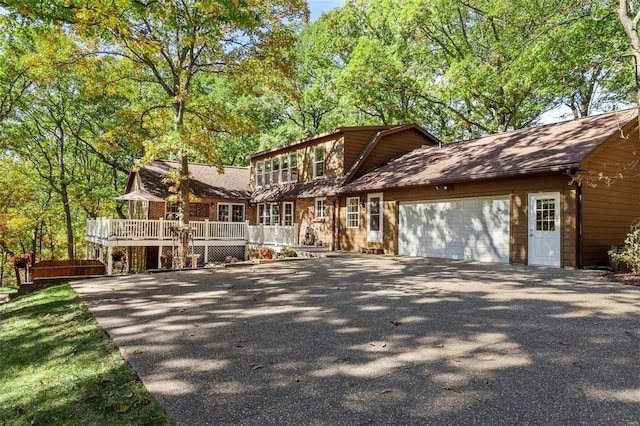 view of front of property featuring a garage and a wooden deck