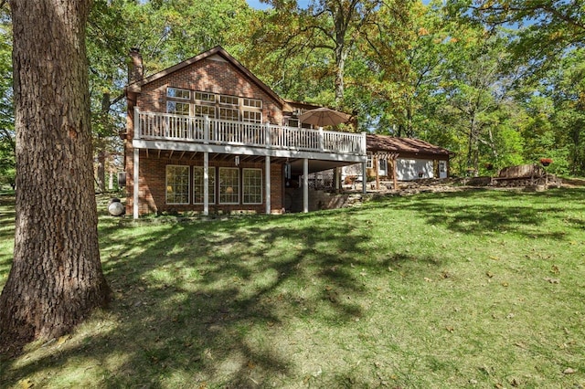 back of property with a wooden deck and a yard