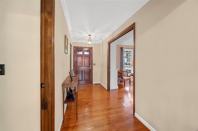 hall featuring ornamental molding and light wood-type flooring