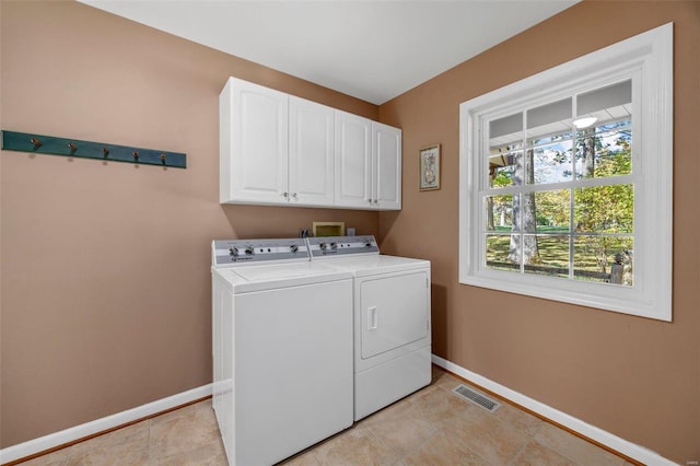 laundry area with cabinets and washing machine and dryer