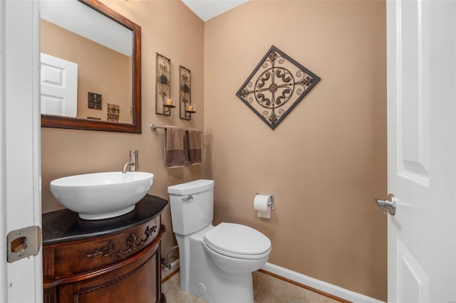 bathroom with vanity, tile patterned floors, and toilet