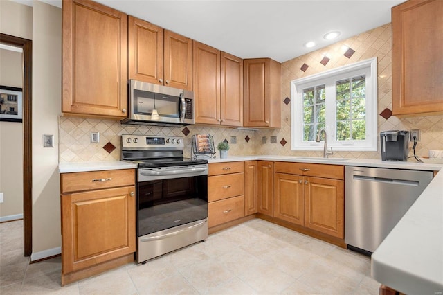 kitchen with sink, decorative backsplash, and appliances with stainless steel finishes