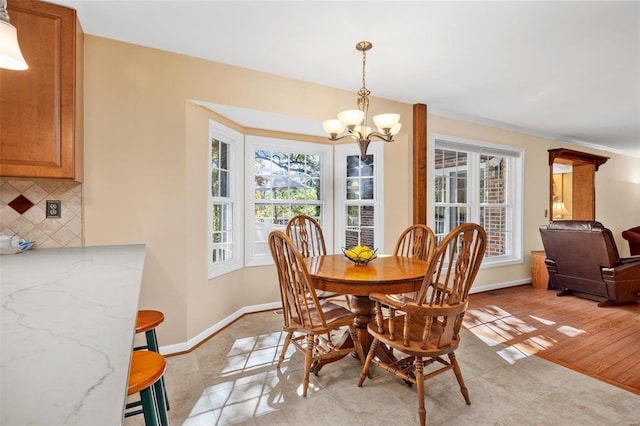 dining room with light tile patterned floors and a chandelier