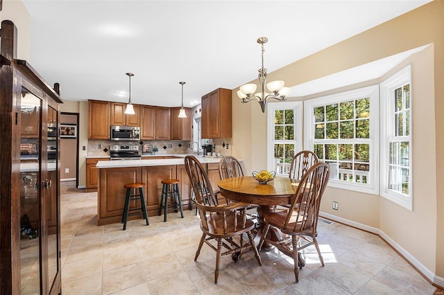 dining space with sink, light tile patterned floors, and a notable chandelier