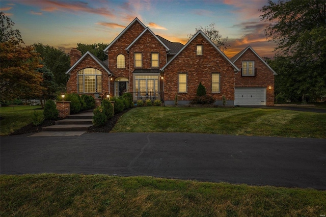 view of front of property featuring a yard and a garage