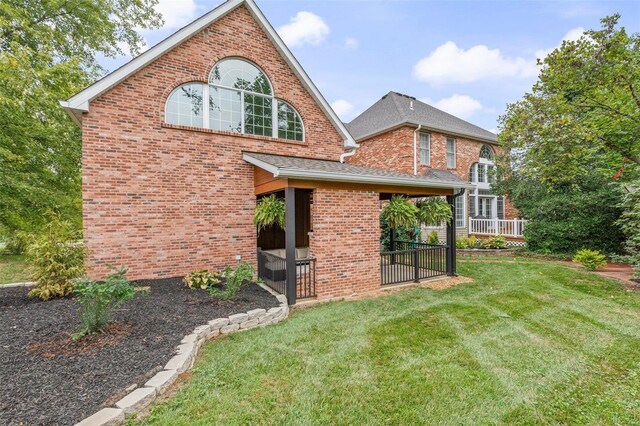 rear view of house with a lawn