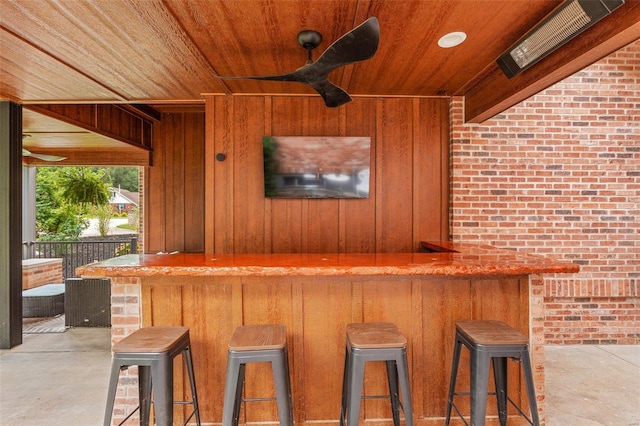 view of patio with exterior bar and ceiling fan