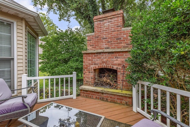 deck featuring an outdoor brick fireplace