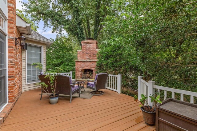 wooden deck with an outdoor brick fireplace