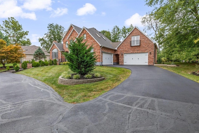 view of front of house with a garage and a front lawn