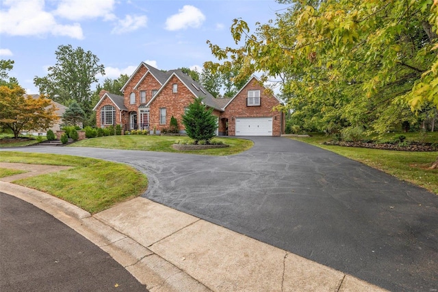 view of front of home featuring a front lawn and a garage