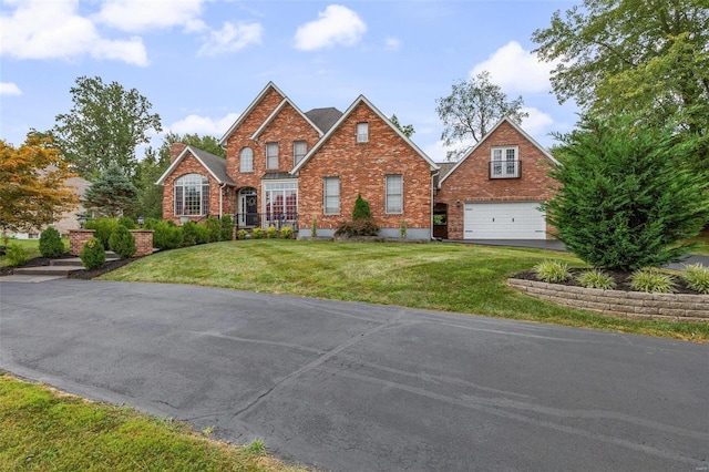 view of front facade with a front yard and a garage