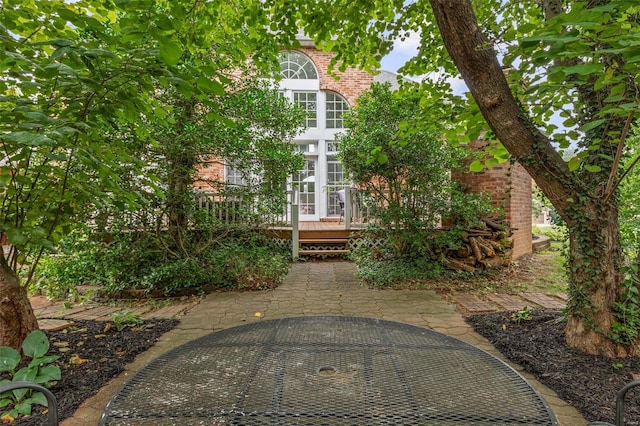 rear view of house featuring french doors and a wooden deck