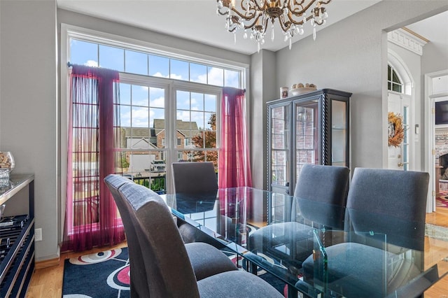 dining space with a notable chandelier and hardwood / wood-style floors