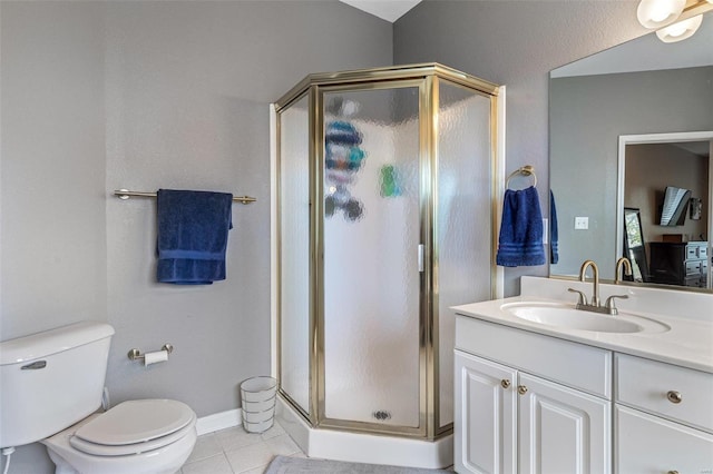 bathroom featuring vanity, a shower with shower door, toilet, and tile patterned floors