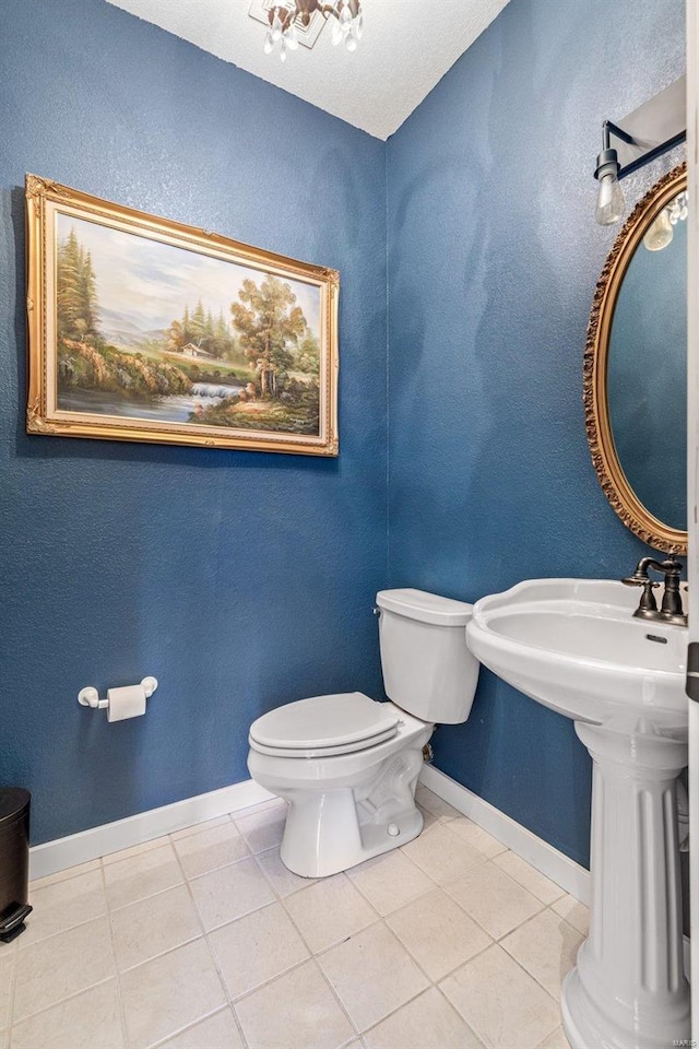 bathroom featuring toilet, a textured ceiling, and tile patterned flooring