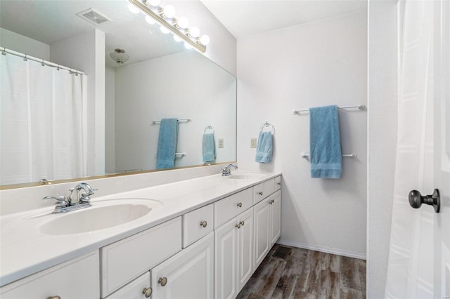 bathroom featuring vanity, wood-type flooring, and curtained shower