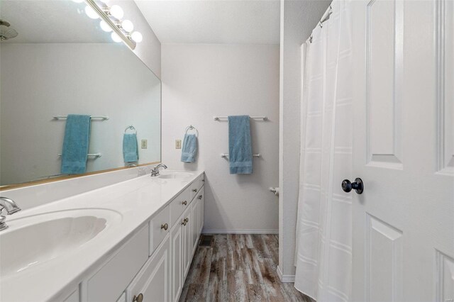 bathroom featuring vanity, hardwood / wood-style floors, and a textured ceiling