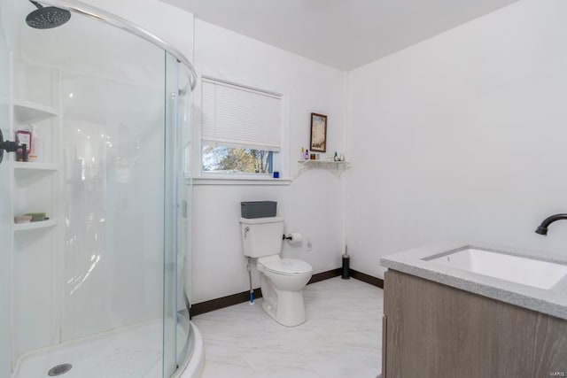 bathroom with vanity, toilet, and a shower with door