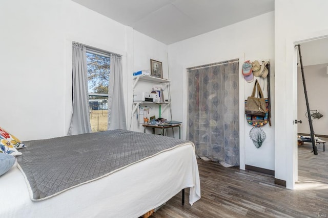 bedroom with dark hardwood / wood-style flooring