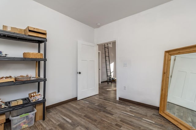 unfurnished bedroom with dark wood-type flooring