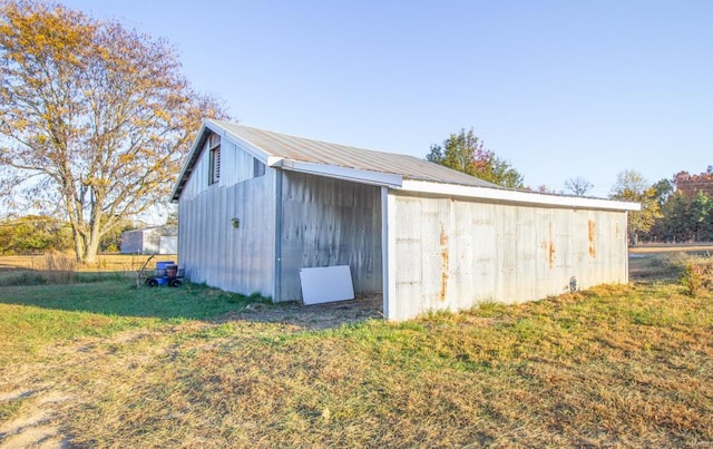 view of outbuilding with a yard