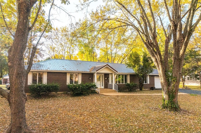 single story home featuring covered porch and a garage