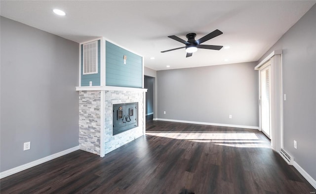 unfurnished living room with dark wood-type flooring, a fireplace, and ceiling fan