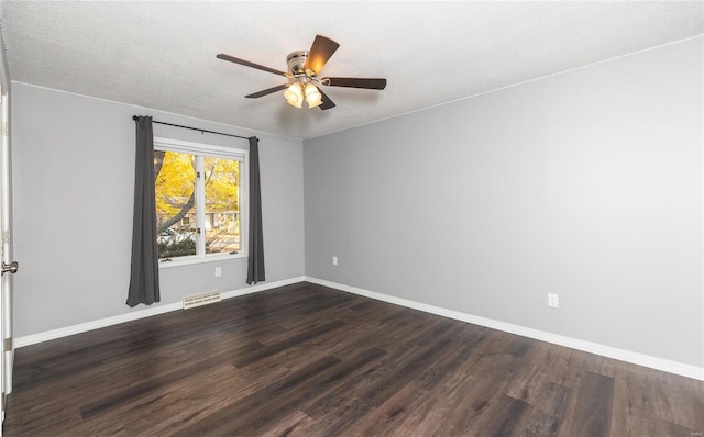 unfurnished room with ceiling fan, a textured ceiling, and dark hardwood / wood-style floors