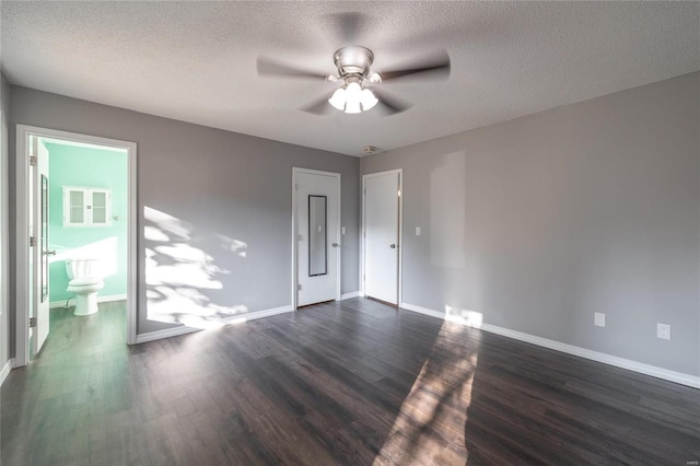 unfurnished room featuring ceiling fan, a textured ceiling, and dark hardwood / wood-style flooring