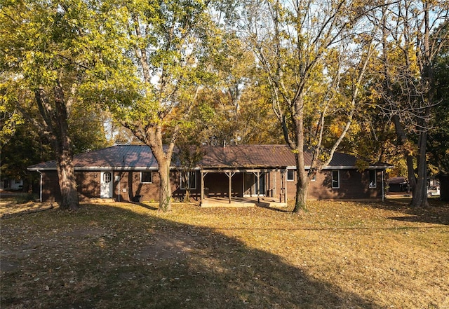 rear view of property featuring a yard