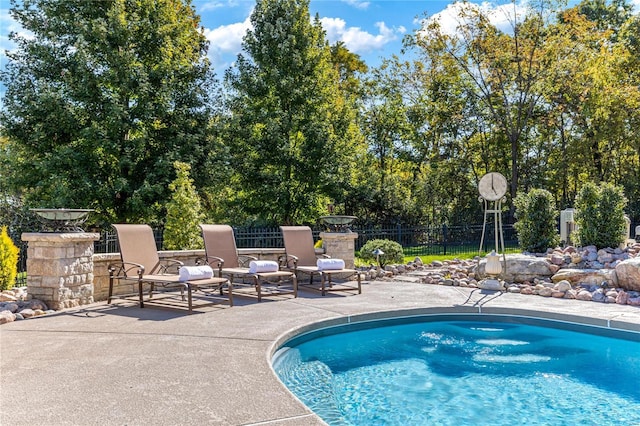 view of swimming pool featuring a patio area