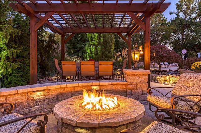 view of patio featuring a pergola and a fire pit