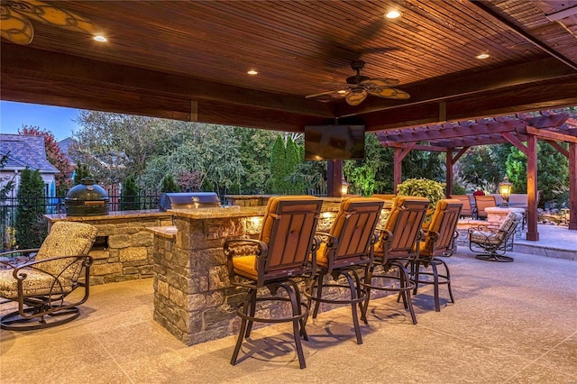 view of patio featuring an outdoor bar, ceiling fan, a pergola, grilling area, and an outdoor kitchen