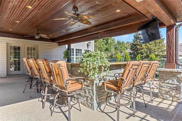 view of patio featuring ceiling fan and an outdoor bar