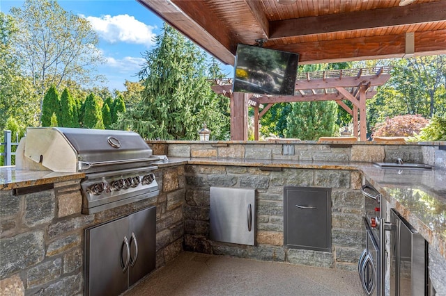 view of patio / terrace featuring wine cooler, a grill, a pergola, and an outdoor kitchen