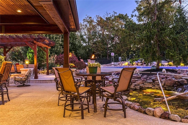 view of patio / terrace featuring a pool and a pergola