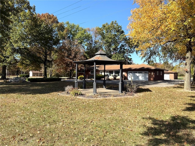 view of yard featuring a garage and a gazebo