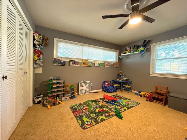 playroom with ceiling fan and carpet flooring