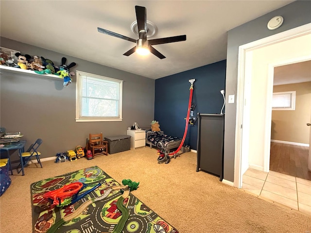 rec room featuring ceiling fan and light carpet