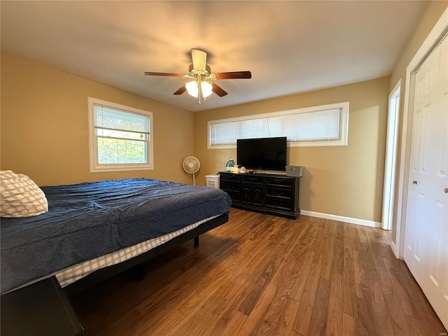 bedroom featuring ceiling fan, wood-type flooring, and a closet