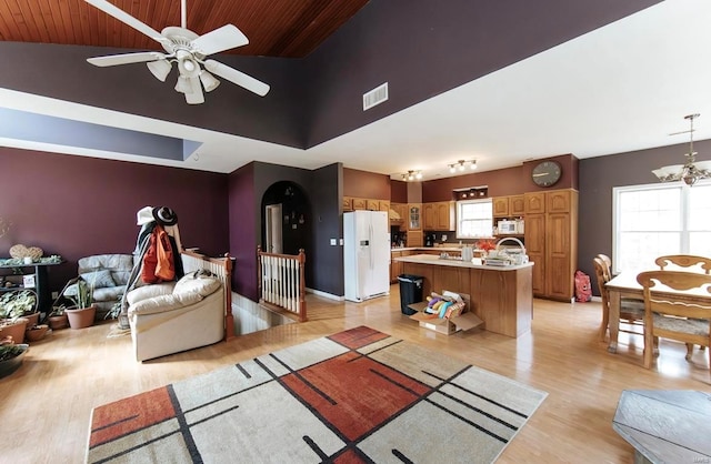 living room with lofted ceiling, ceiling fan with notable chandelier, light wood-type flooring, and wooden ceiling