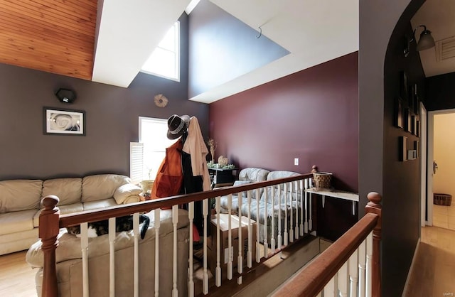 interior space featuring a crib, multiple windows, and hardwood / wood-style floors