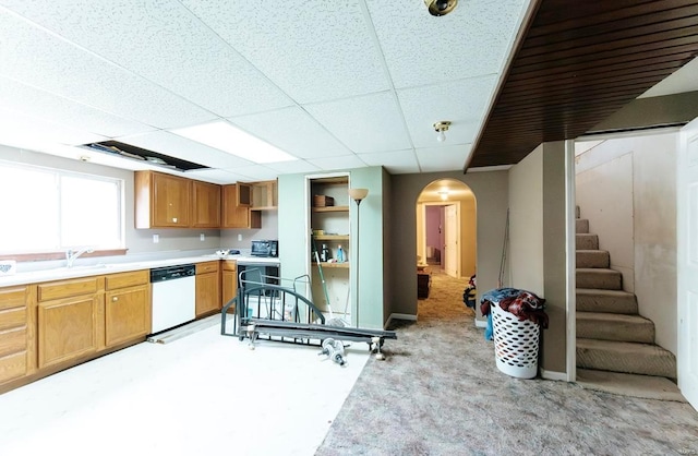 kitchen with light carpet, a paneled ceiling, sink, and white dishwasher