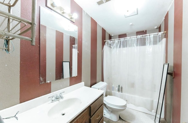 full bathroom with vanity, shower / tub combo, and toilet