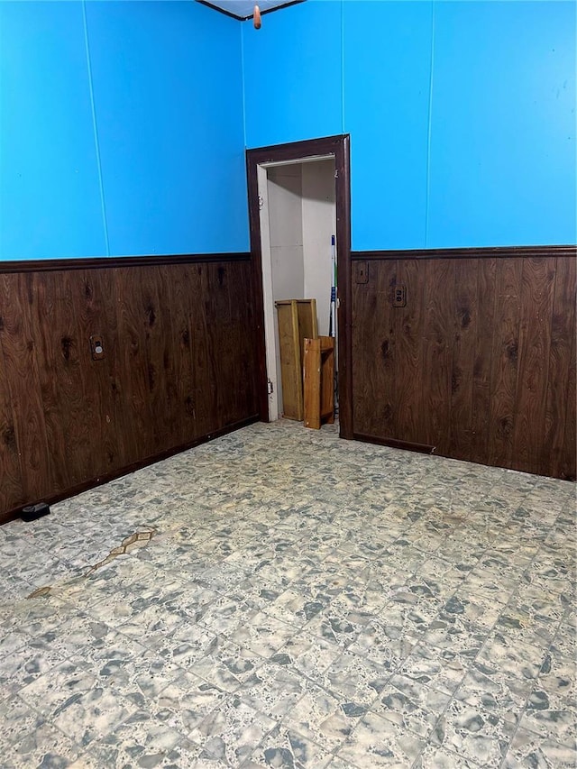 spare room with wood walls