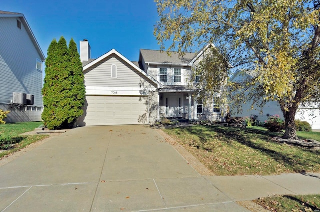 view of front of house with a front yard and a garage